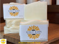 Sunlit Soaps Naked Tallow Soap on a wooden surface with packaging.