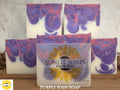 Sunlit Soaps Purple Rain soap bars on a wooden surface with a marble background