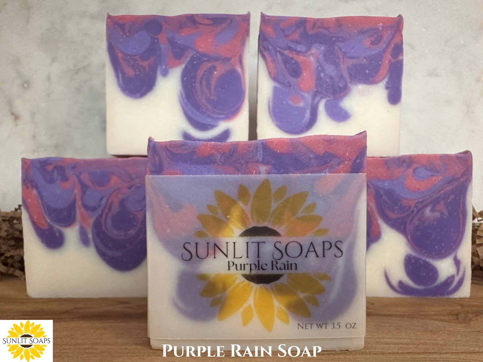 Sunlit Soaps Purple Rain soap bars on a wooden surface with a marble background